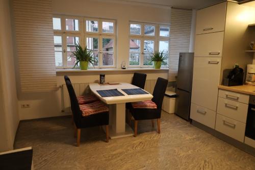 a kitchen with a table and chairs in a room at Romantisches Main Erlebnis in Gemünden