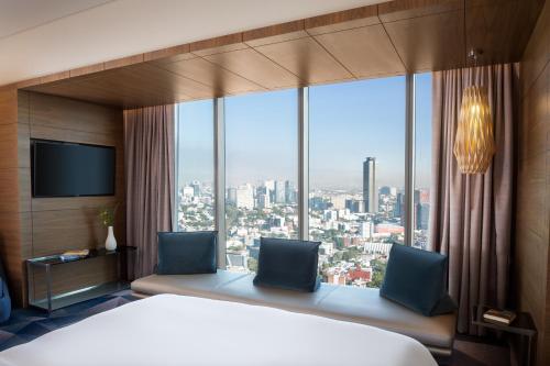 a hotel room with a bed and a large window at Sofitel Mexico City Reforma in Mexico City