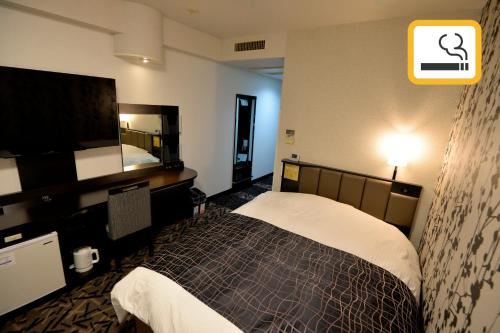 Voodi või voodid majutusasutuse APA Hotel Mie Kameyama toas