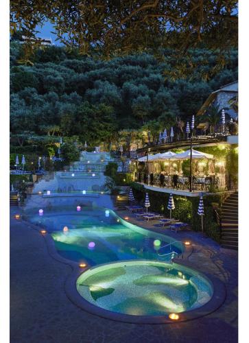 a row of pools at a resort at night at Grand Hotel Capodimonte in Sorrento