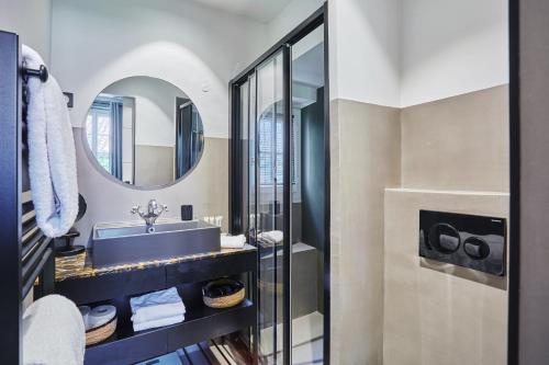 a bathroom with a sink and a mirror at Hôtel de Charme Bello Visto in Gassin