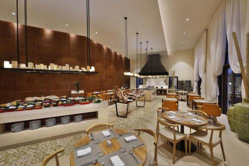 a restaurant with tables and chairs and a buffet at Al Manara, a Luxury Collection Hotel, Aqaba in Aqaba