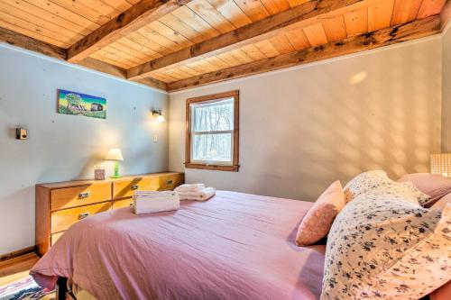 a bedroom with a large bed and a window at West Cornwall Cabin about 4 Mi to Covered Bridge! in West Cornwall