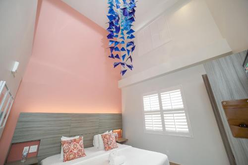 a bedroom with a bed with a blue decoration on the wall at The Julia Hotel in Miami Beach