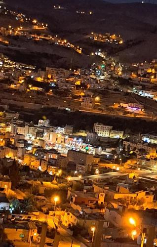 a view of a city at night with lights at Leen Guest House in Wadi Musa