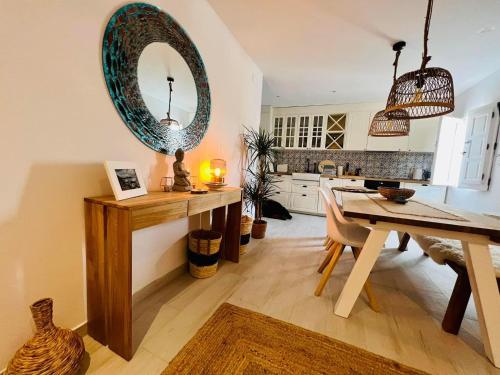 a kitchen with a table and a mirror on the wall at Casa MiraMar in Salobreña
