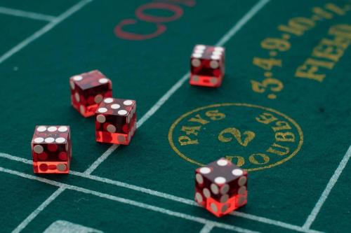 a group of red dice on a poker table at Relaxing 5-Bedroom Villa with Outdoor Oasis in Bay Saint Louis