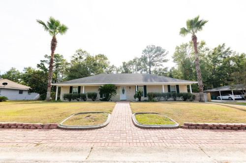 a house with two mounds in the front yard at Relaxing 5-Bedroom Villa with Outdoor Oasis in Bay Saint Louis