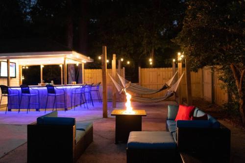 a patio with a fire pit with chairs and a table at Relaxing 5-Bedroom Villa with Outdoor Oasis in Bay Saint Louis
