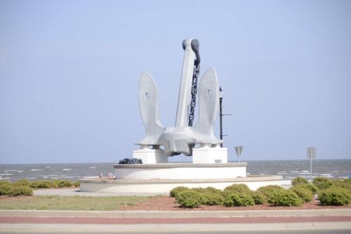 a statue of a space shuttle on top of a field at Relaxing 5-Bedroom Villa with Outdoor Oasis in Bay Saint Louis