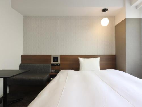 Кровать или кровати в номере HOTEL M's EST KYOTO STATION SOUTH