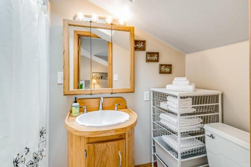 a bathroom with a sink and a mirror and towels at Port Susan Bay - A in Sunny Shore Acres