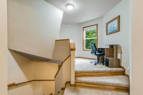 a home office with stairs and a chair at Port Susan Bay - A in Sunny Shore Acres