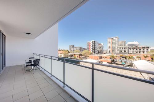 a balcony with a view of a city at Adina Apartment Hotel Wollongong in Wollongong