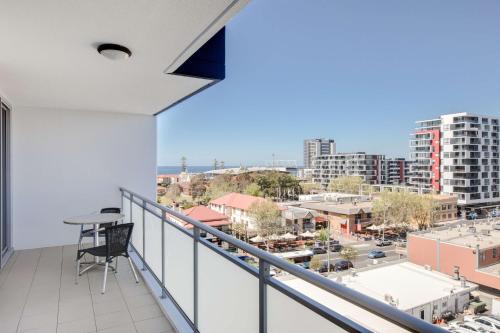 a balcony with a view of a city at Adina Apartment Hotel Wollongong in Wollongong