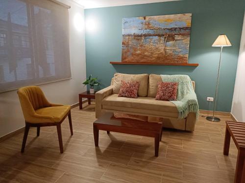 a living room with a couch and a chair at Hotel Boutique Confort Suites in Popayan