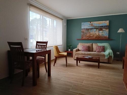 a living room with a couch and a table at Hotel Boutique Confort Suites in Popayan