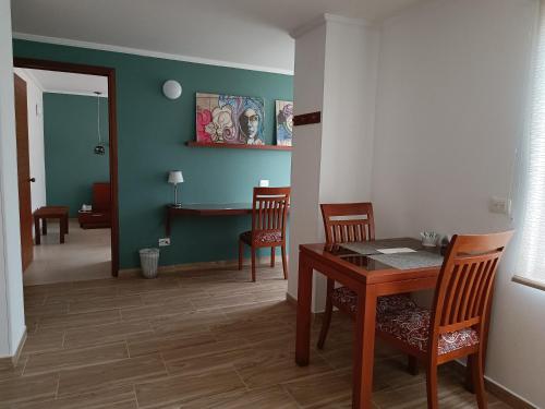 a dining room with a table and chairs in a room at Hotel Boutique Confort Suites in Popayan