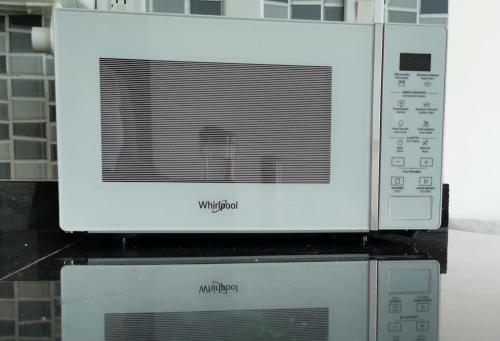 a microwave oven sitting on top of two microwaves at Coti’s house in Río Hato