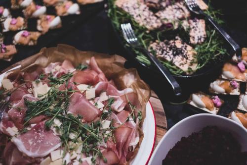 a table topped with a pizza and other plates of food at Radisson Collection, Strand Hotel, Stockholm in Stockholm
