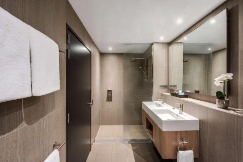 a bathroom with a sink and a shower at Vibe Hotel North Sydney in Sydney