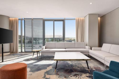 a living room with a couch and a table at Radisson Blu Hotel Riyadh Convention and Exhibition Center in Riyadh