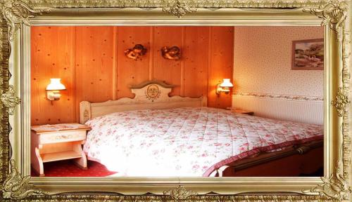 a bedroom with a large bed in a frame at Landhaus Hotel Romantik in Gotha