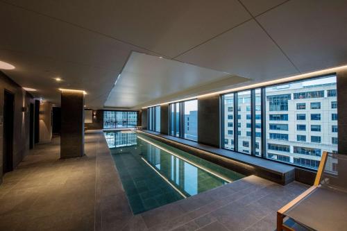 a swimming pool with a view of a building at Vibe Hotel Hobart in Hobart