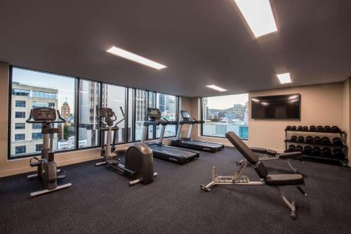 a gym with treadmills and ellipticals in a building at Vibe Hotel Hobart in Hobart
