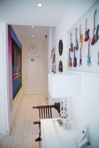 a room with a table and a shelf with guitars at Big Johnny B in Rome