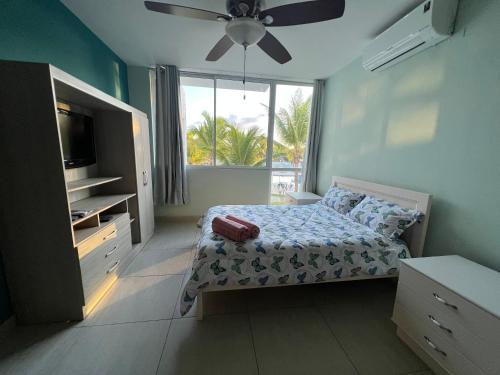 a bedroom with a bed and a large window at Coti’s house in Río Hato