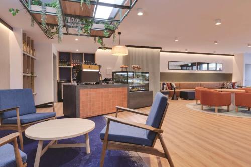 a lobby with chairs and tables and a bar at Travelodge Hotel Hurstville Sydney in Sydney