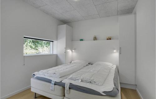 a bedroom with a bed with white walls and a window at Stunning Home In Hemmet With Wifi in Hemmet