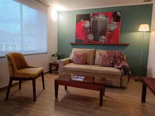 a living room with a couch and a table at Hotel Boutique Confort Suites in Popayan