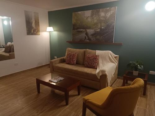 a living room with a couch and a table at Hotel Boutique Confort Suites in Popayan