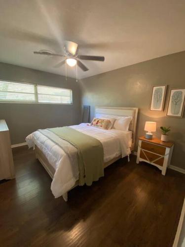 a bedroom with a bed and a ceiling fan at Happy Days at Two Oaks in Lakeland