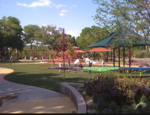 a park with a playground with people in it at Happy Days at Two Oaks in Lakeland