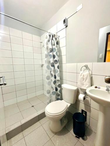 a bathroom with a toilet and a sink at Hospedaje La Posada del Chino in Los Órganos
