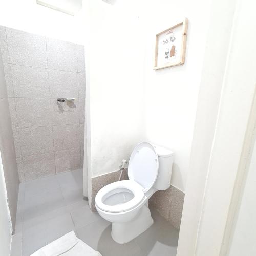 a bathroom with a toilet and a shower at The Forest Villa in Bogor