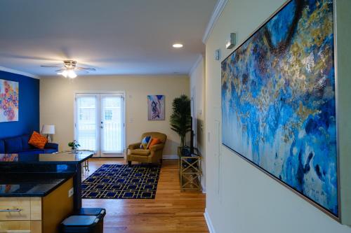 a living room with a large painting on the wall at Amazing ATL downtown houses - minutes walk to bars, food and transport! in Atlanta