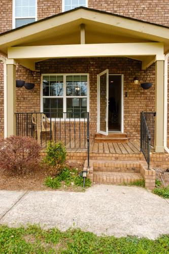 a brick house with a porch with a patio at Amazing ATL downtown houses - minutes walk to bars, food and transport! in Atlanta