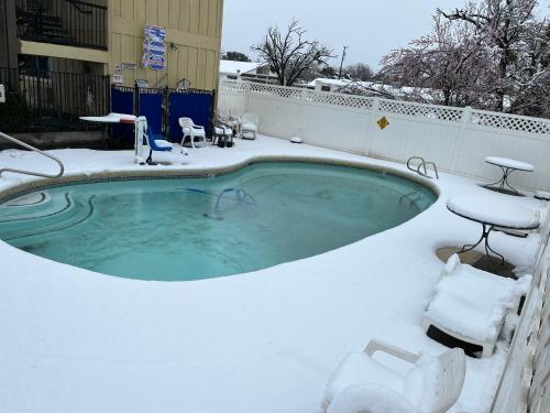 a swimming pool covered in snow at Super 8 by Wyndham Red Bluff in Red Bluff
