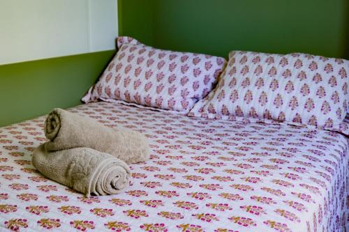 a stuffed teddy bear laying on a bed at Container Bem-te-Vi! in Siderópolis