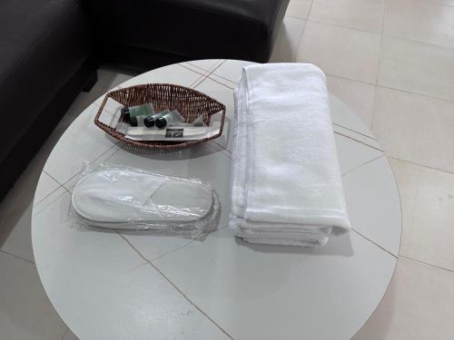 a white table with a basket on top of it at Homestay Mama, Kota Bharu in Kota Bharu