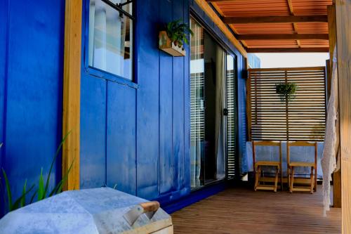 a blue house with a blue door and a balcony at Container com clima de montanha! in Siderópolis