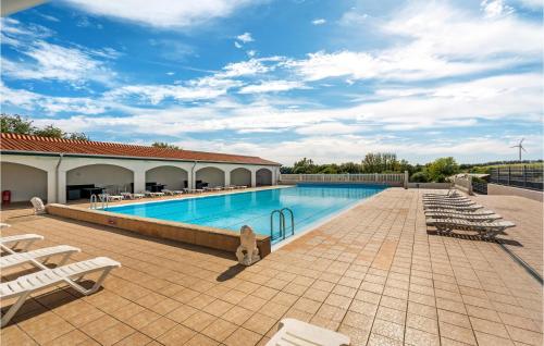 a large swimming pool with lounge chairs on a patio at Stunning Home In Tranekær in Tranekær