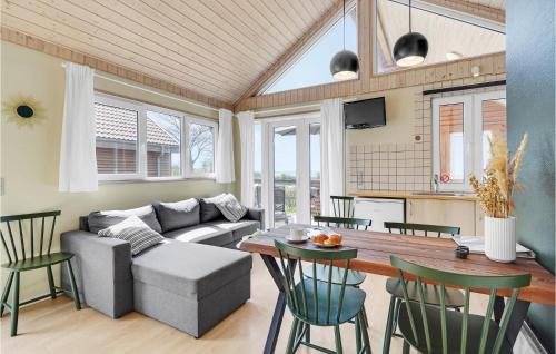 a living room with a couch and a table at Stunning Home In Tranekær in Tranekær