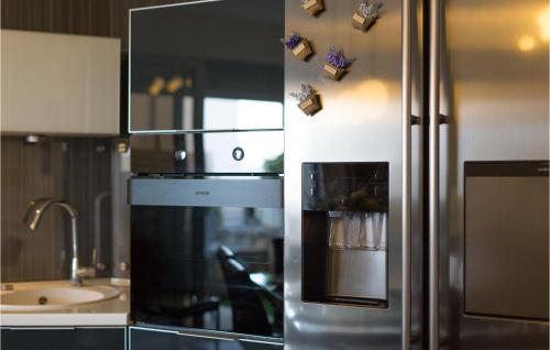 a kitchen with a stainless steel refrigerator and a sink at Nice Home In Krk With Wifi in Krk