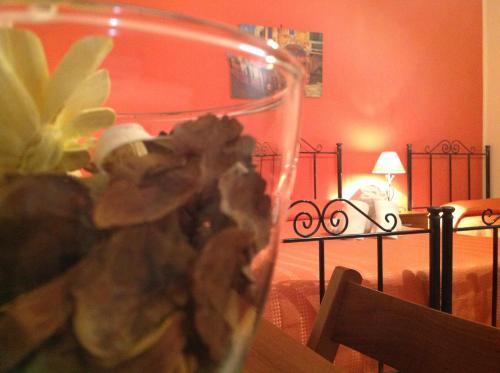 a glass vase with a flower on a table at Il Cavaliere in Trapani