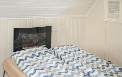 a bed in a room with a fireplace at 2 Bedroom Cozy Home In Halden in Halden